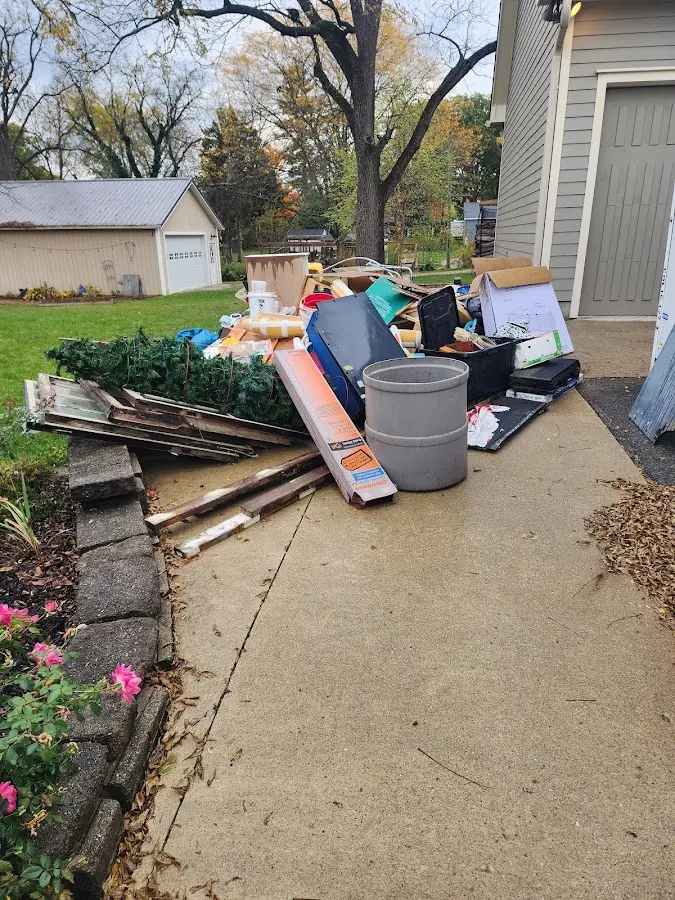 Dumpster being loaded with debris for Estate Cleanout Dumpster Rental in Cloquet